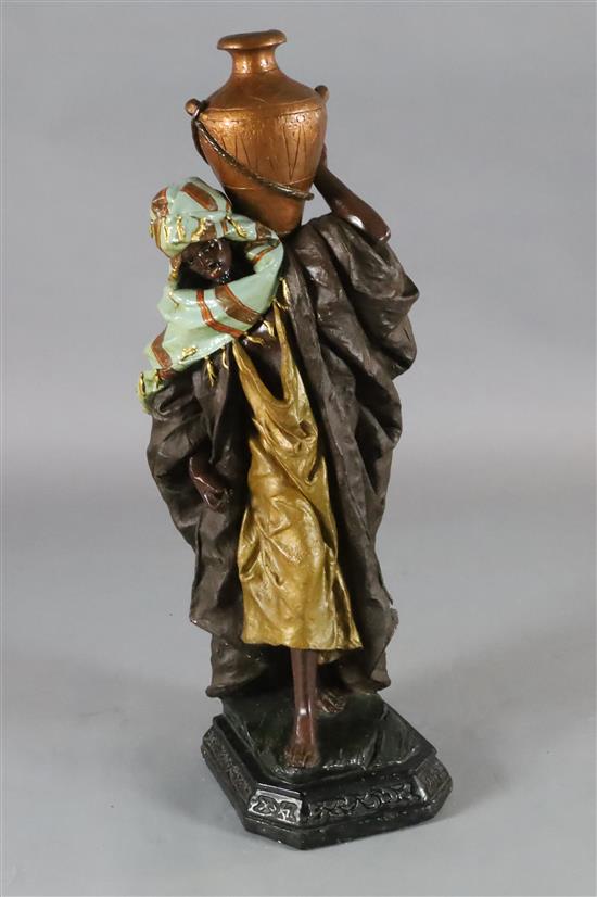 A Goldscheider style painted plaster figure of an Arab water carrier, H.40in.
